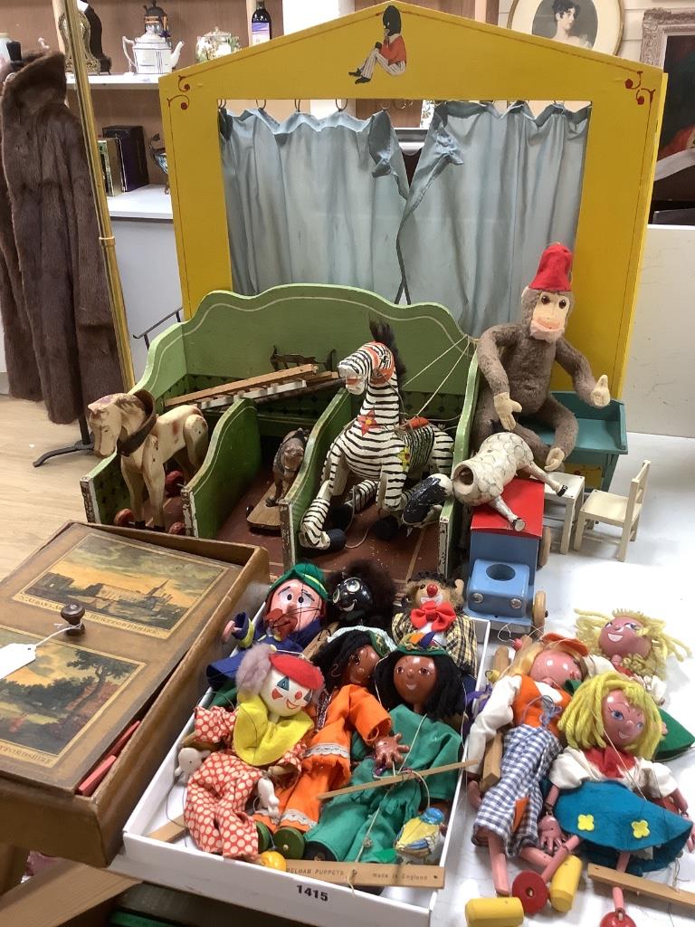 A collection of antique toys, to include a collection of puppets and a toy proscenium theatre